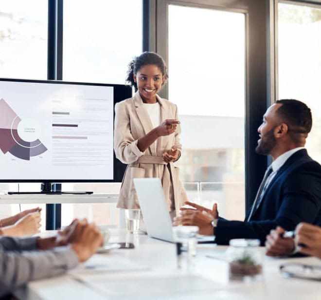 woman giving a presentation in a conference room using ScreenBeam tech